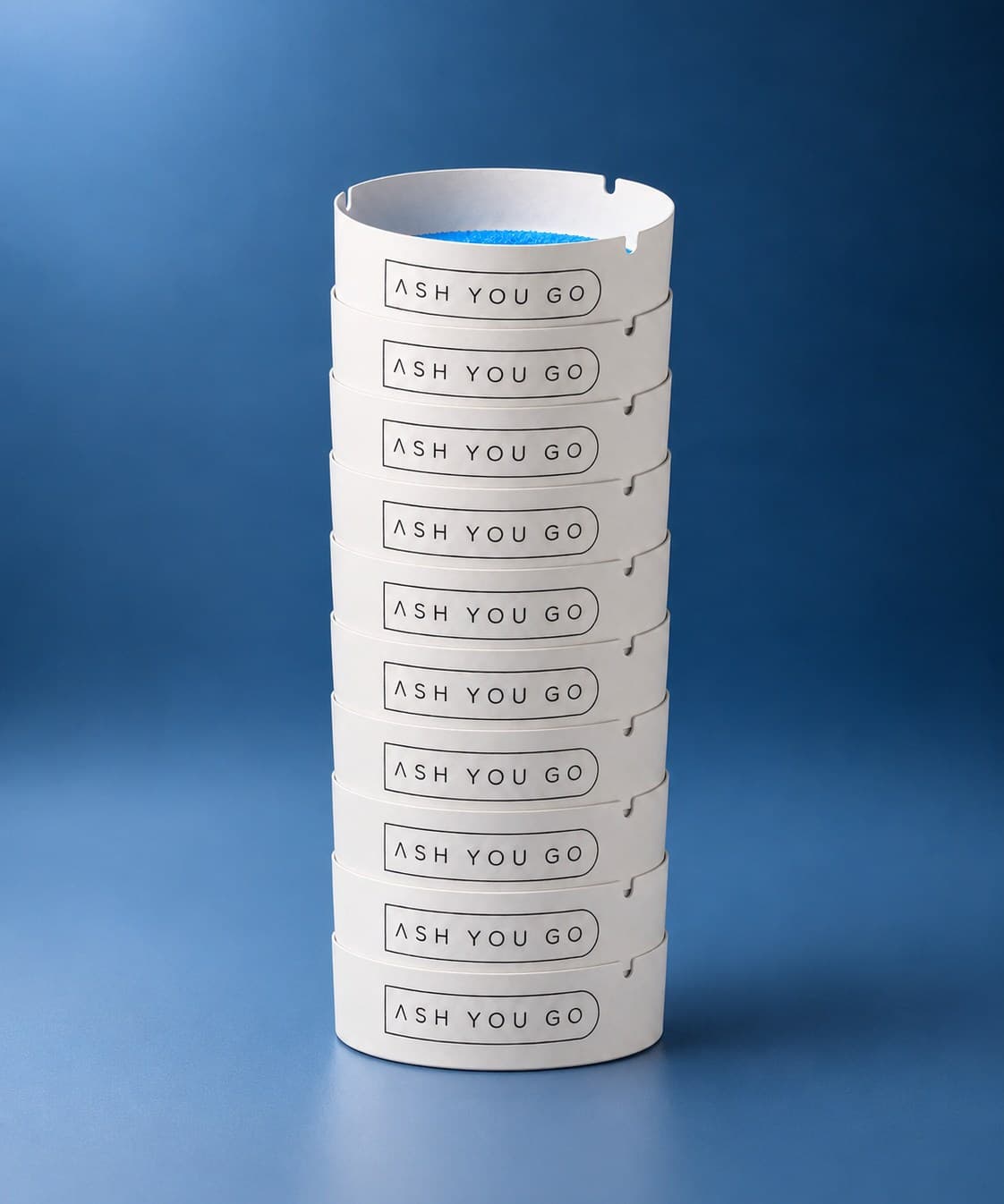 Stack of 10 ASH YOU GO trays on a deep blue backdrop